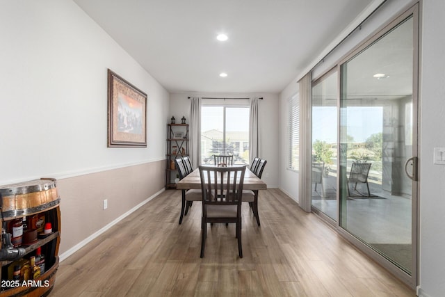 dining space with light hardwood / wood-style floors