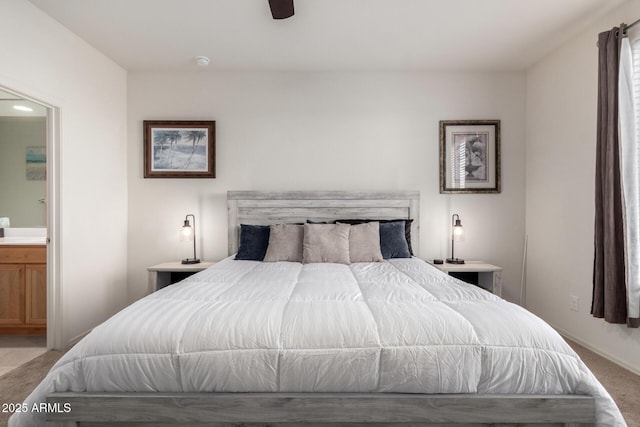 bedroom featuring light carpet, connected bathroom, and ceiling fan