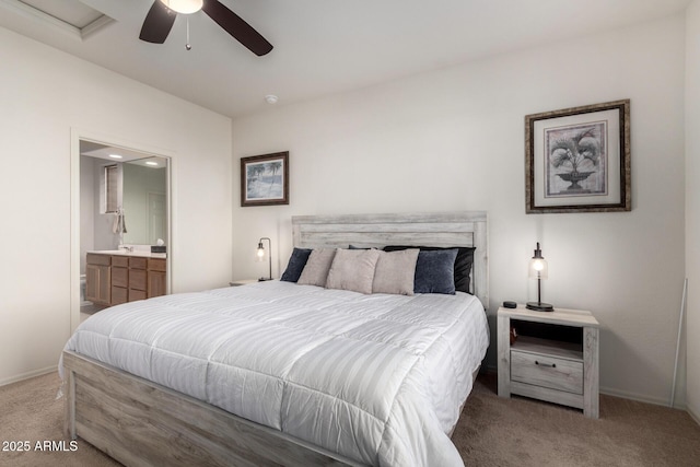 carpeted bedroom with ceiling fan and ensuite bathroom