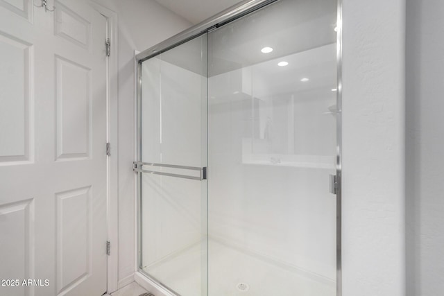 bathroom featuring a shower with door