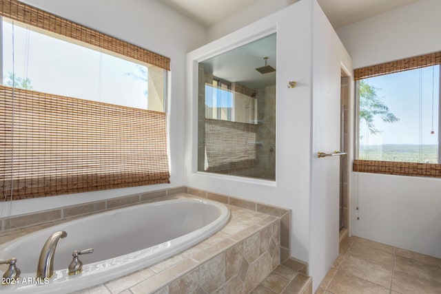 bathroom featuring tile patterned flooring and plus walk in shower