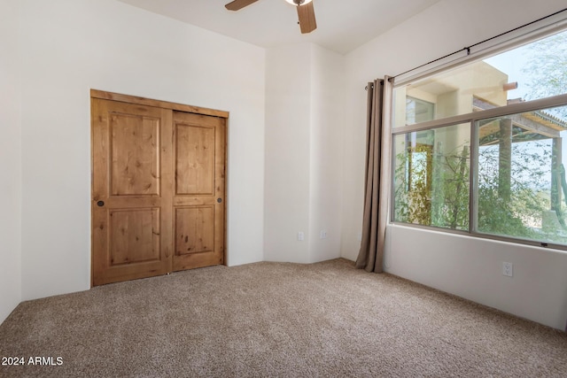 unfurnished bedroom featuring carpet and ceiling fan