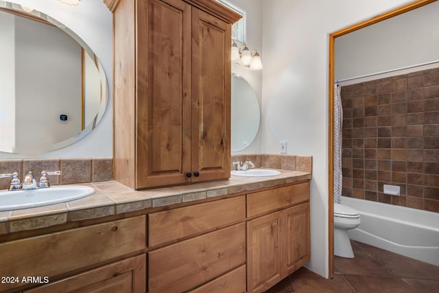 full bathroom with tile patterned floors, vanity, shower / tub combo, and toilet