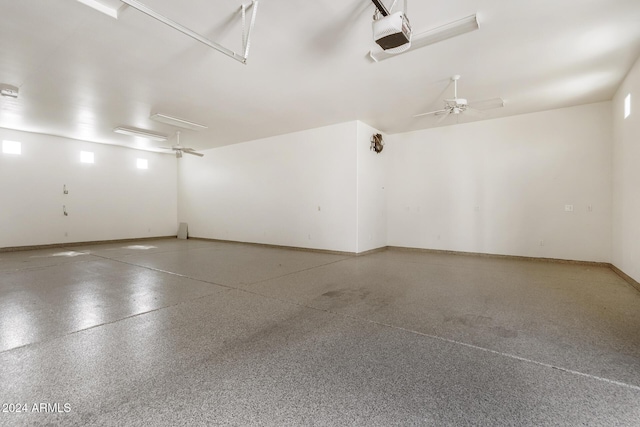 garage with ceiling fan and a garage door opener