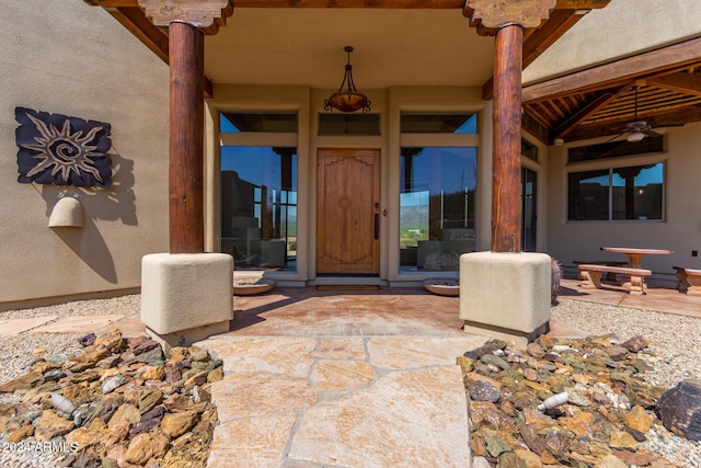 entrance to property with ceiling fan