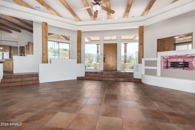 interior space featuring ceiling fan, beam ceiling, and high vaulted ceiling