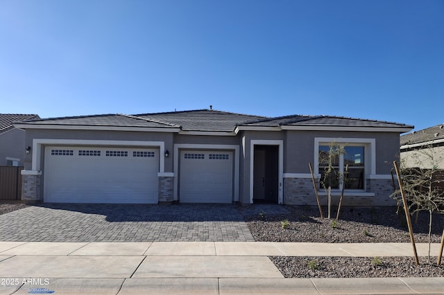 24152 N 172nd Ave, Surprise, AZ 85387 - prairie-style house with decorative driveway, a garage, and stucco siding