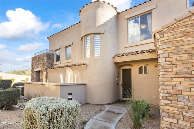 19475 N Grayhawk Dr Unit 1115, Scottsdale, AZ 85255 - view of front of home featuring stucco siding, a tiled roof, and stone siding