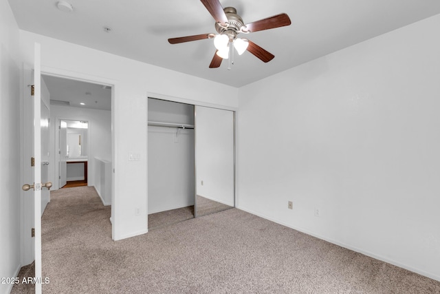 unfurnished bedroom with a closet, baseboards, a ceiling fan, and carpet floors