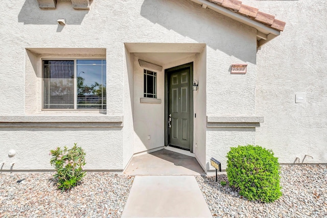 property entrance with stucco siding