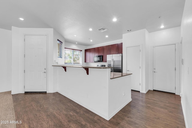 kitchen with stainless steel fridge with ice dispenser, black microwave, a peninsula, dark wood-type flooring, and visible vents