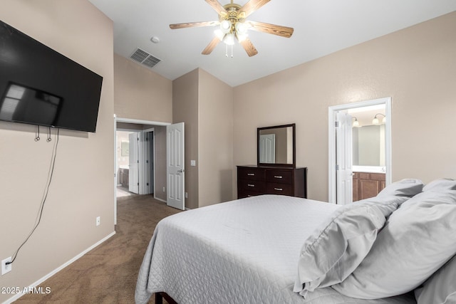 bedroom with connected bathroom, vaulted ceiling, ceiling fan, and dark colored carpet