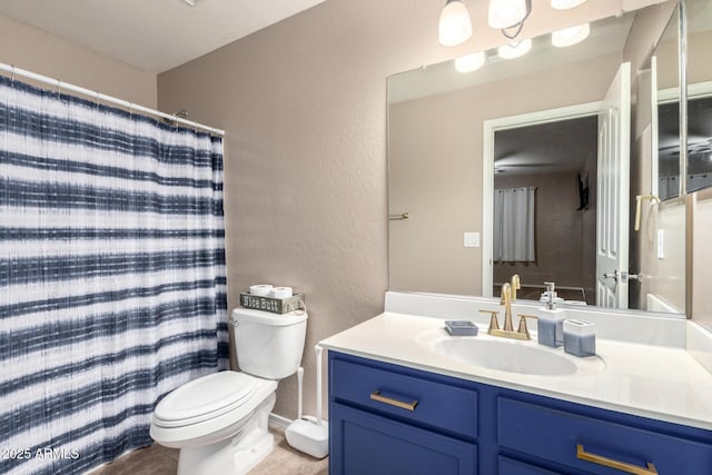 bathroom with vanity, curtained shower, and toilet