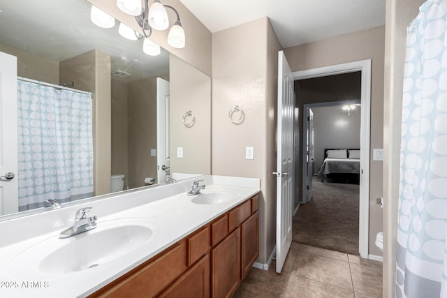 bathroom with tile patterned flooring, vanity, a shower with shower curtain, and toilet