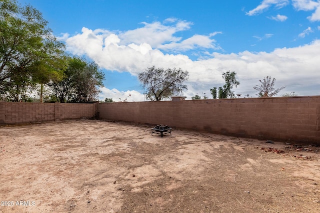 view of yard with a fire pit