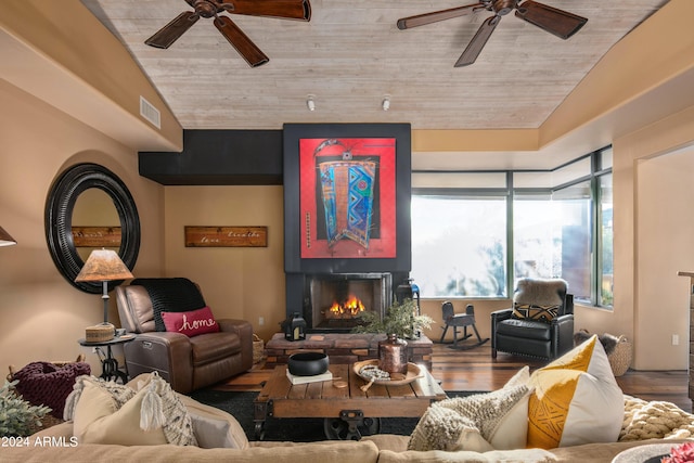 living room with lofted ceiling, ceiling fan, and dark hardwood / wood-style flooring