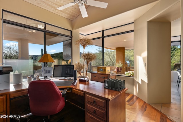 office space featuring vaulted ceiling, ceiling fan, and light wood-type flooring