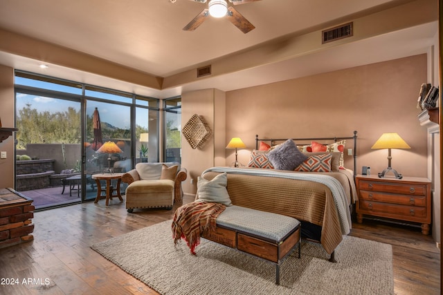 bedroom with dark hardwood / wood-style flooring, ceiling fan, and access to outside