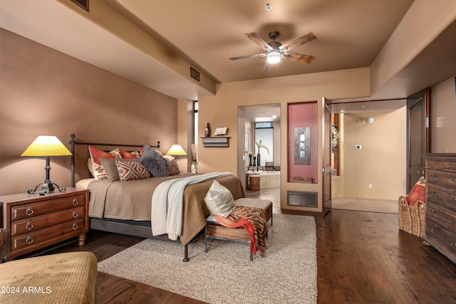 bedroom featuring ceiling fan, dark hardwood / wood-style flooring, and connected bathroom