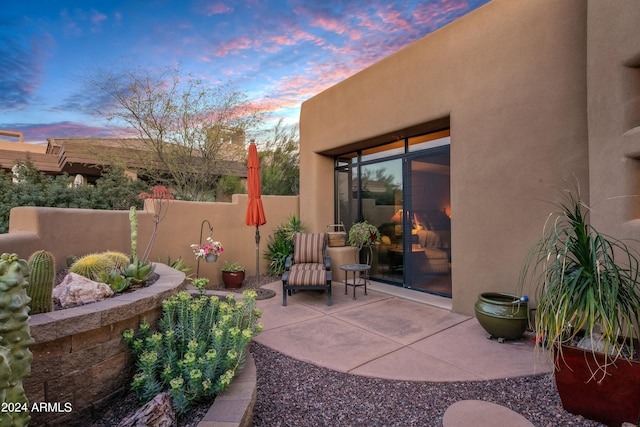 view of patio terrace at dusk