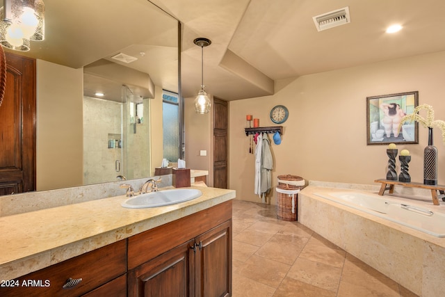 bathroom with plus walk in shower, tile floors, and vanity with extensive cabinet space