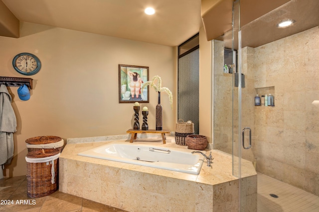 bathroom featuring plus walk in shower and tile flooring