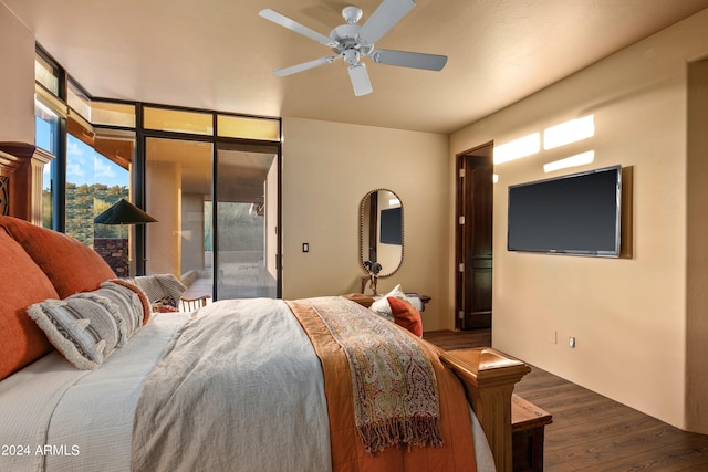 bedroom with floor to ceiling windows, dark wood-type flooring, ceiling fan, and access to outside