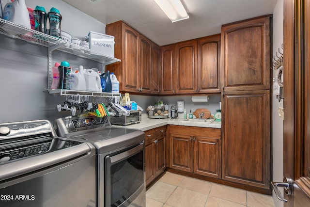 kitchen featuring washing machine and dryer and light tile floors