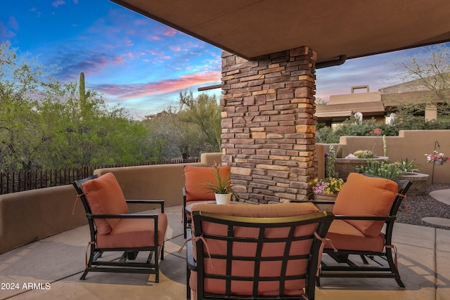 patio terrace at dusk featuring an outdoor hangout area