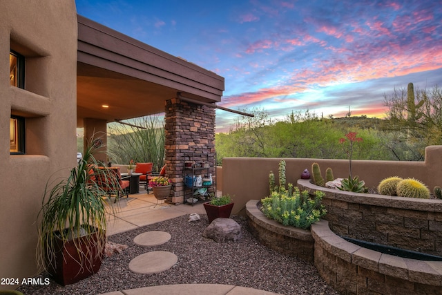 view of patio terrace at dusk