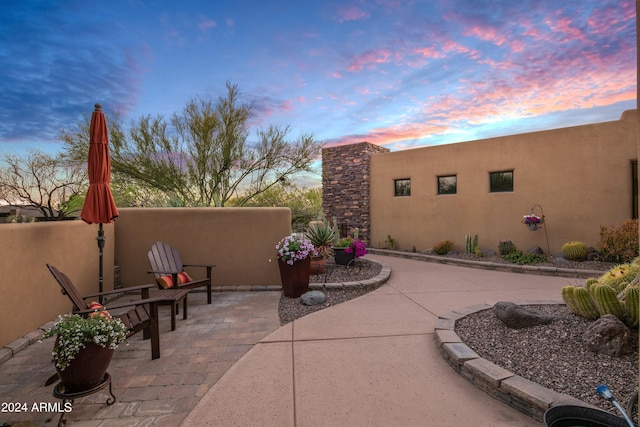 view of patio terrace at dusk