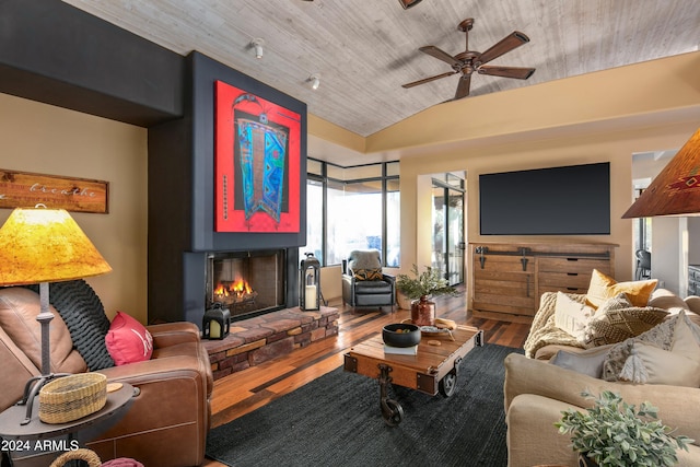 living room featuring a fireplace, hardwood / wood-style floors, and ceiling fan