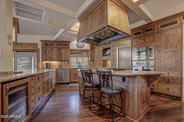 kitchen with built in appliances, wine cooler, a breakfast bar, dark wood-style flooring, and a center island