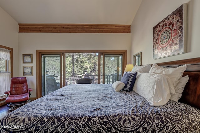 bedroom featuring lofted ceiling, access to outside, multiple windows, and wood finished floors