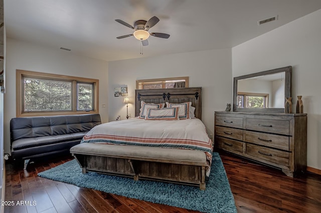 bedroom with dark wood-style flooring, visible vents, and ceiling fan