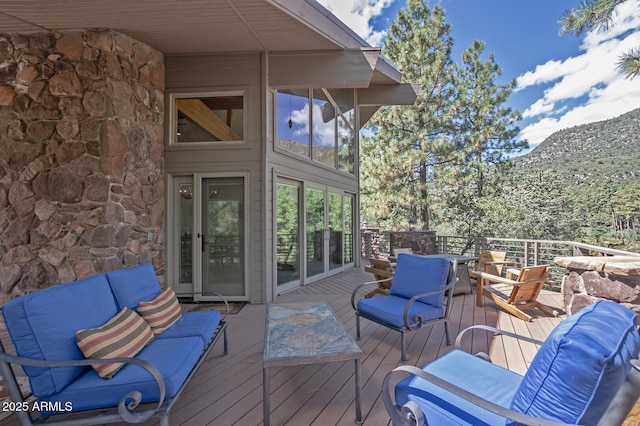 wooden terrace featuring an outdoor living space