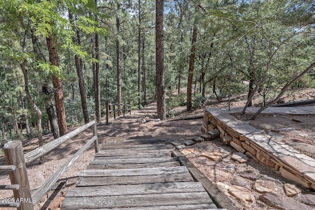 surrounding community featuring a wooded view