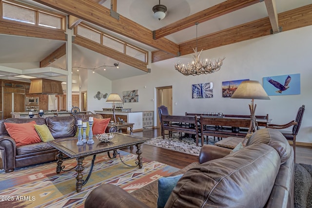 living area featuring beam ceiling, an inviting chandelier, wood finished floors, high vaulted ceiling, and baseboards