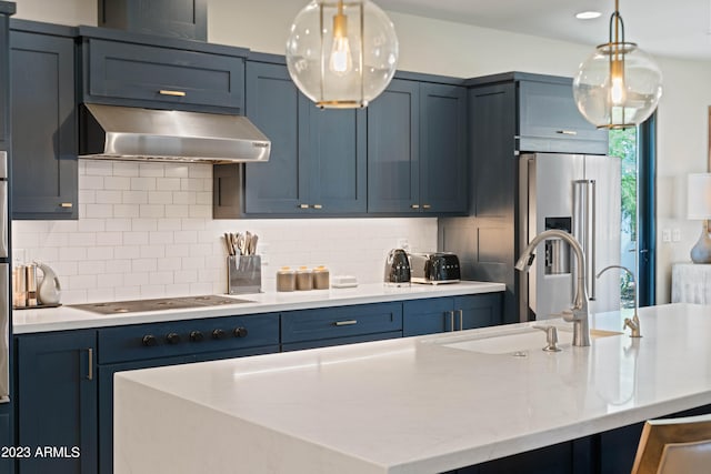 kitchen with ventilation hood, decorative light fixtures, high end fridge, and blue cabinetry