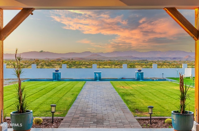 view of home's community featuring a lawn and a water and mountain view