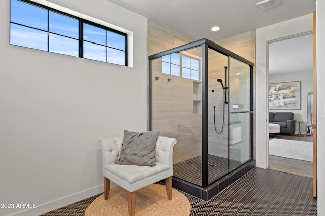 bathroom featuring walk in shower and hardwood / wood-style flooring