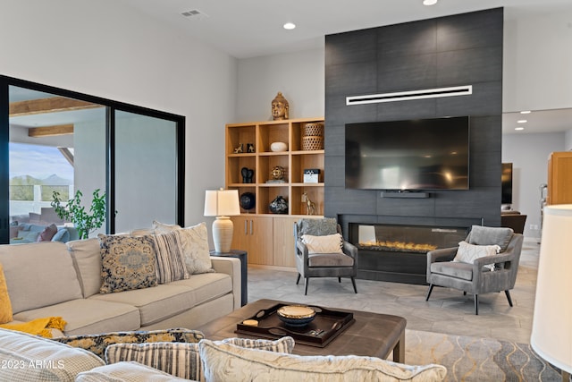 living room featuring a high ceiling and a fireplace