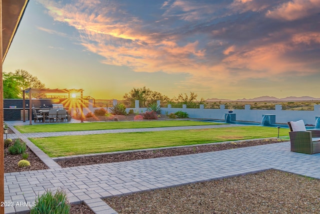 yard at dusk with a patio area