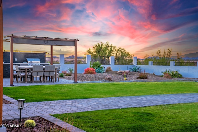 yard at dusk featuring a patio area