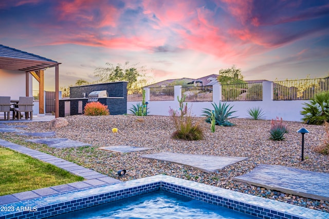 view of pool at dusk