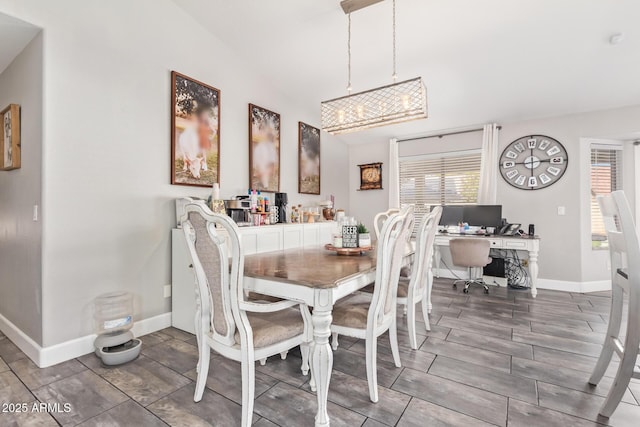 dining room featuring lofted ceiling