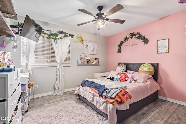 bedroom with ceiling fan and light hardwood / wood-style floors