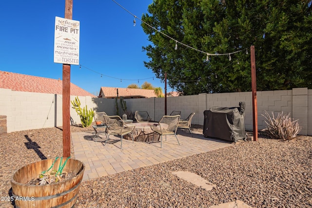 view of patio / terrace featuring area for grilling and a fire pit