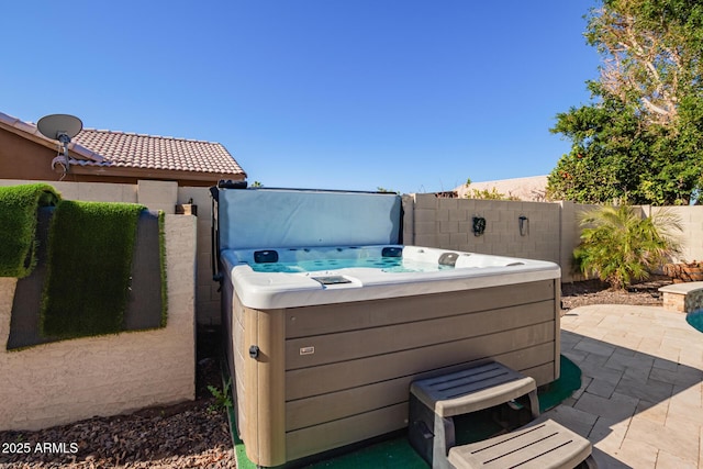 view of patio / terrace with a hot tub