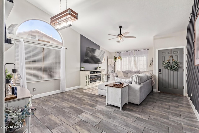 living room featuring vaulted ceiling and ceiling fan